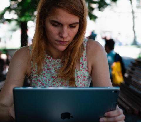 Image of woman reading something on her laptop