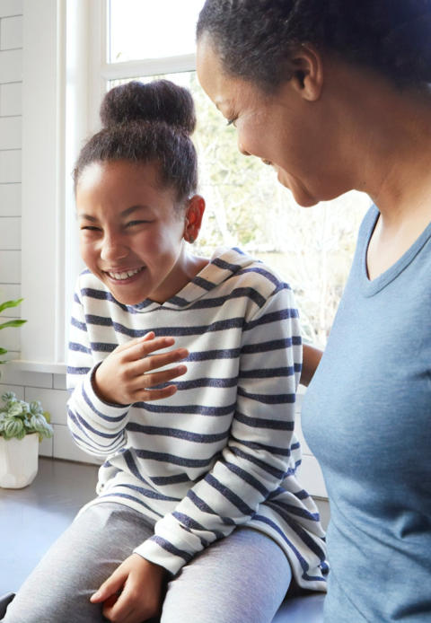 Image of mother with daughter laughing together