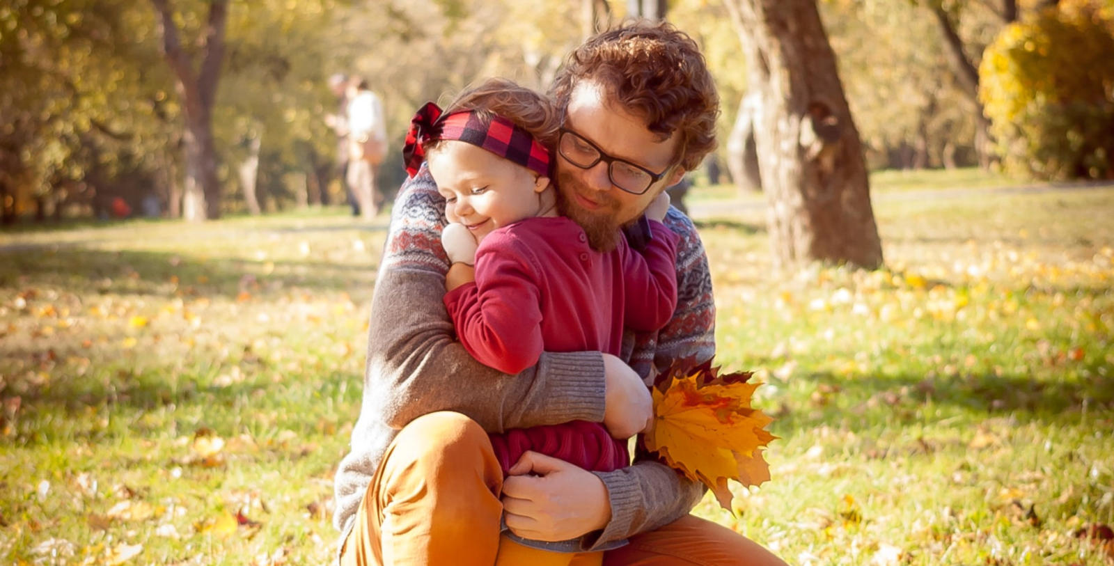 Image of a happy father hugging his smiling little girl