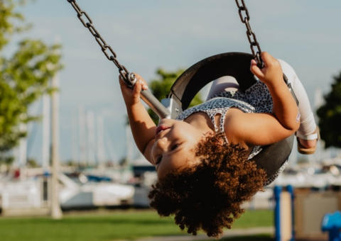 Image of a little girl having fun on a swing