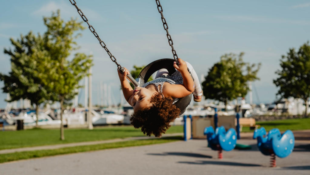 Image of a little girl having fun on a swing